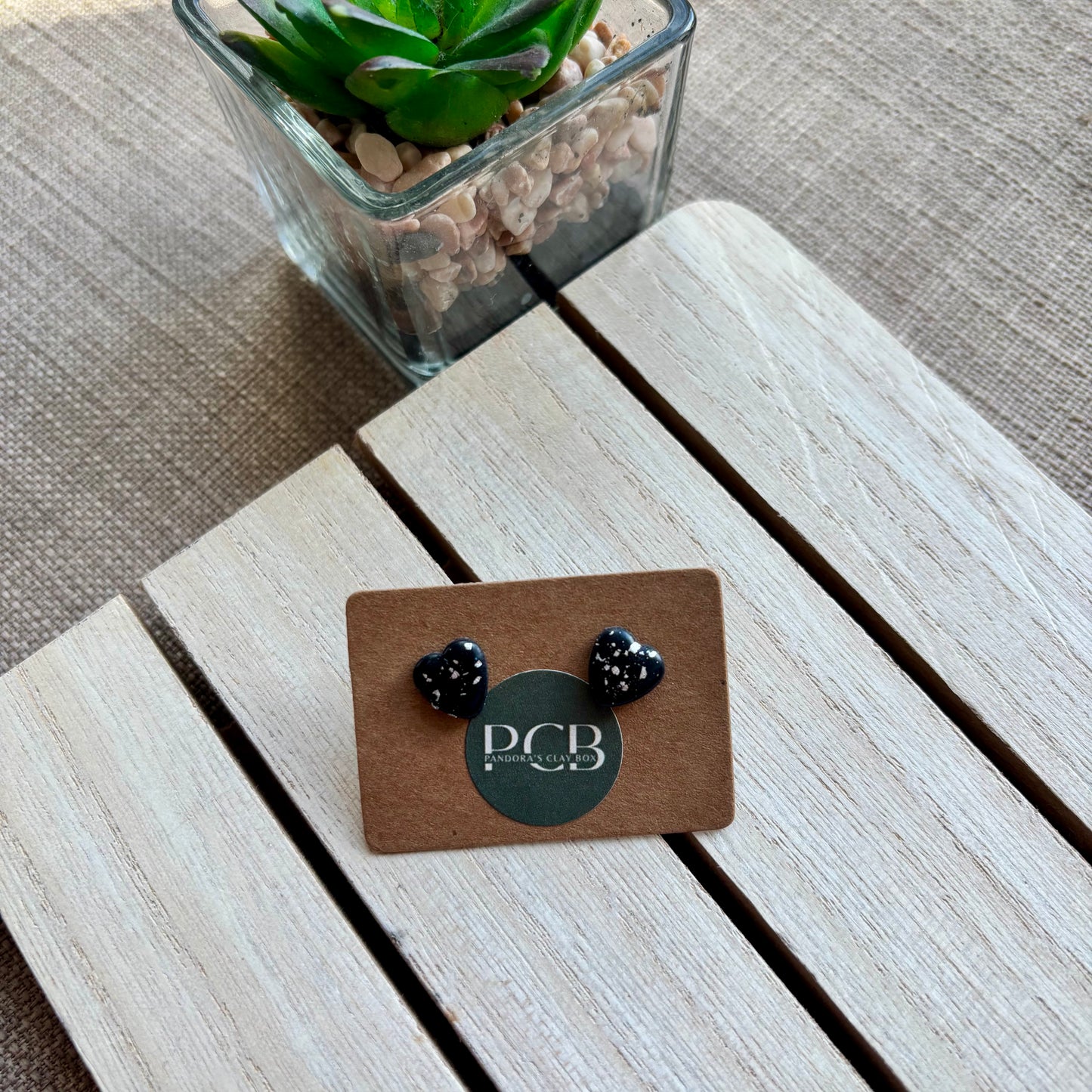 Black/silver heart studs