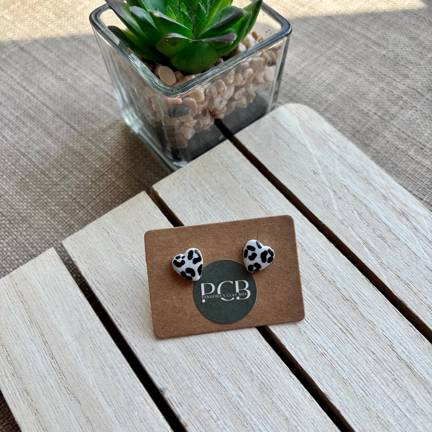 Grey leopard heart studs